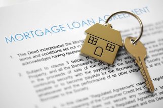 Mortgage application with house keys on top
