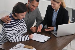 A young couple sat with a conveyancing solicitor